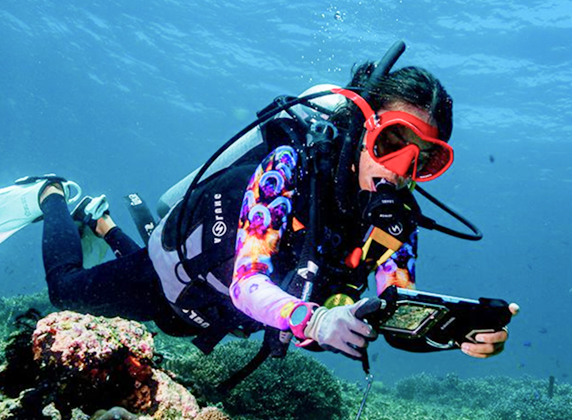 Scuba diver doing a rapid reef assessment of the health of the coral