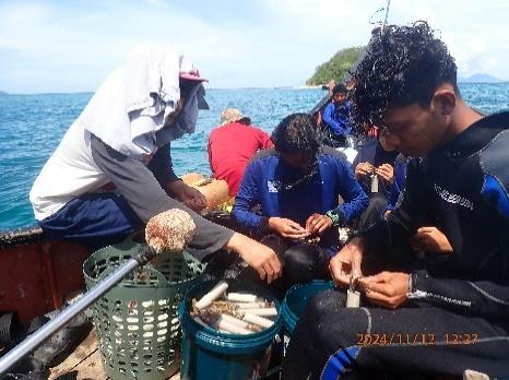 Indonesian youths preparing for coral restoration on a boat.