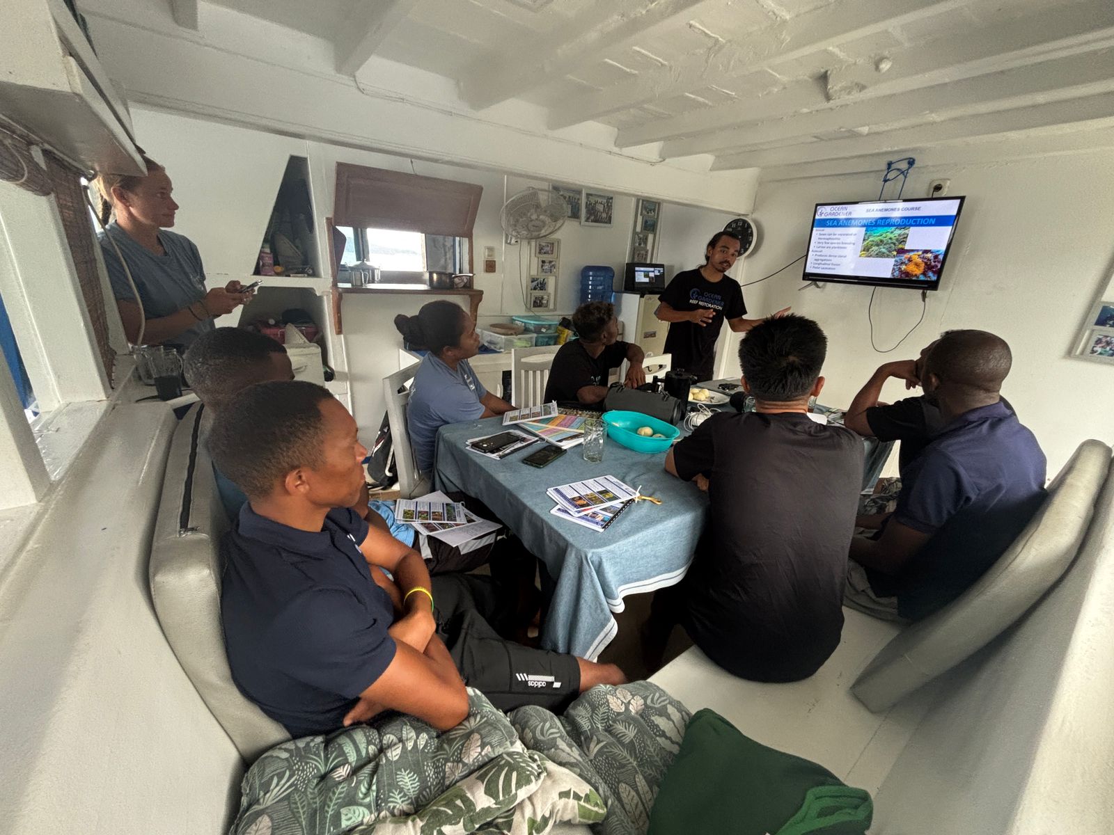 Ocean Gardener team member explaining clownfish biology in our coral restoration course.