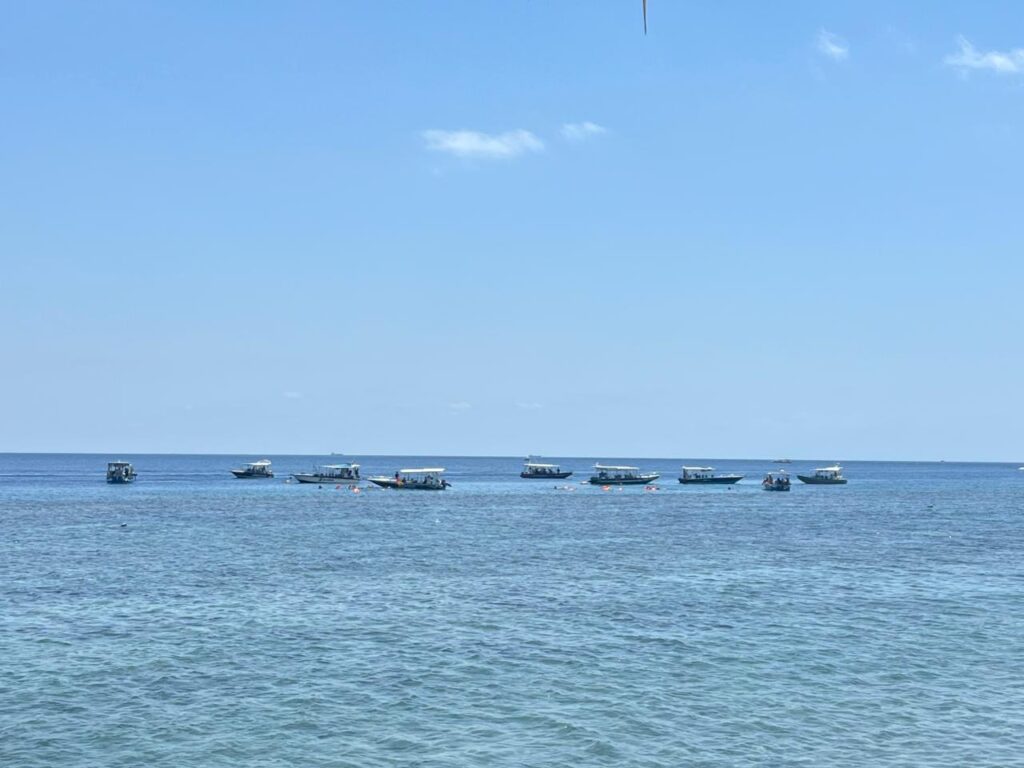 Tourist boats parked dangerously close to the reef in Indonesia